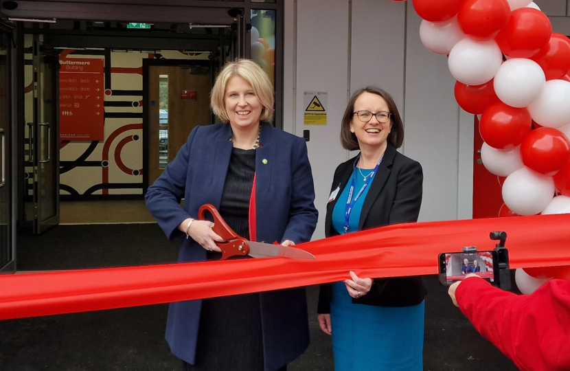 Katherine Fletcher outside the new building at Runshaw. She is stood with the Principal of the college, and has a large pair of scissors in her hand, ready to cut the ribbon.