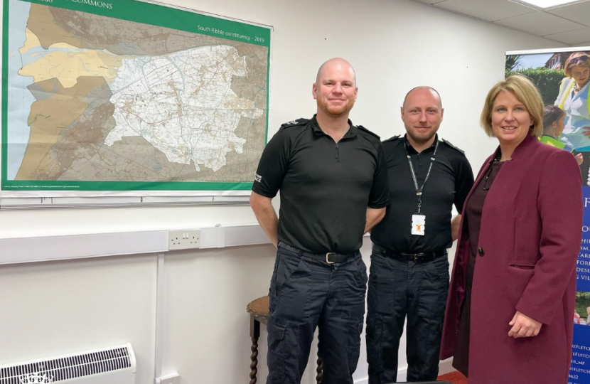 Katherine Fletcher stood in a room with two police officers. A map of South Ribble is behind them.