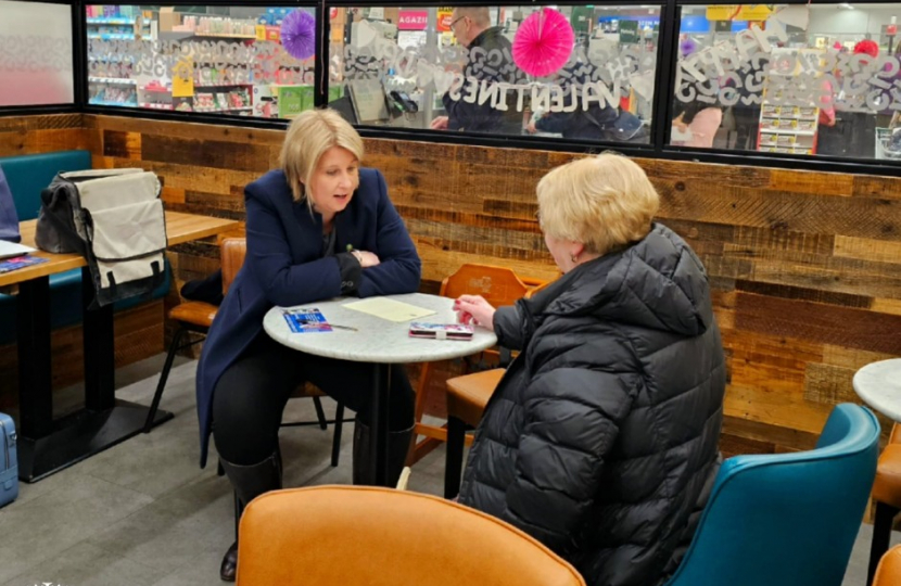 Katherine Fletcher sat in a Morrisons Café, talking to a constituent