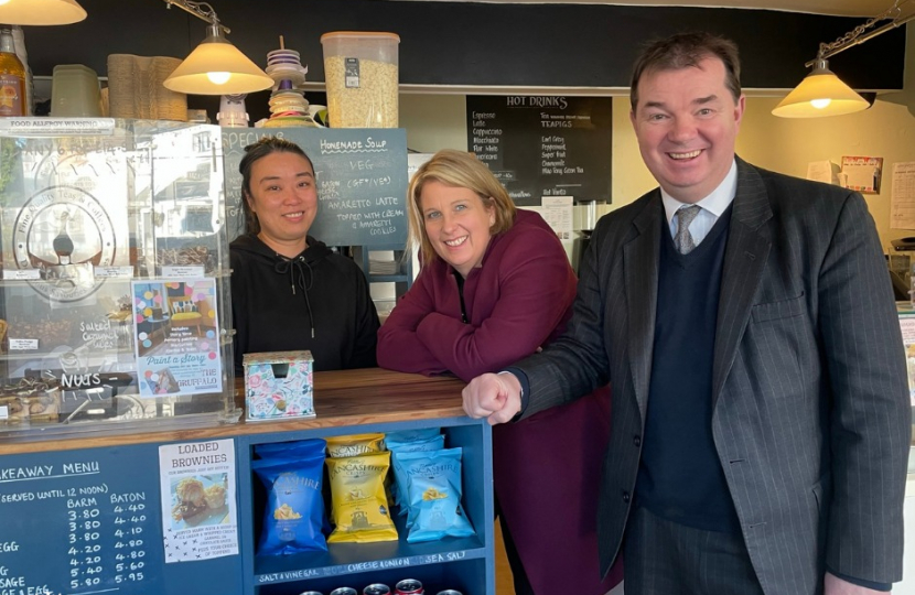 Katherine Fletcher with Guy Opperman and a member of staff in a small café.