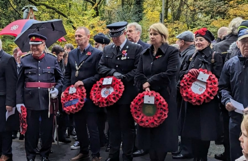 Katherine in a group photo holding a wreath