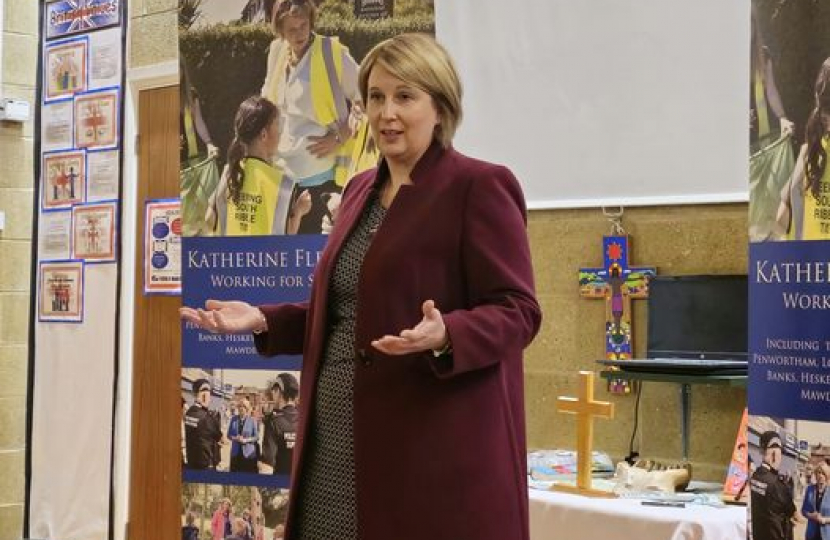 Katherine speaking at front of school hall