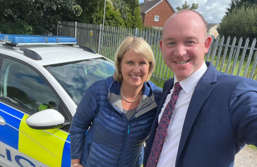 Katherine standing beside a police car with Andrew Snowden