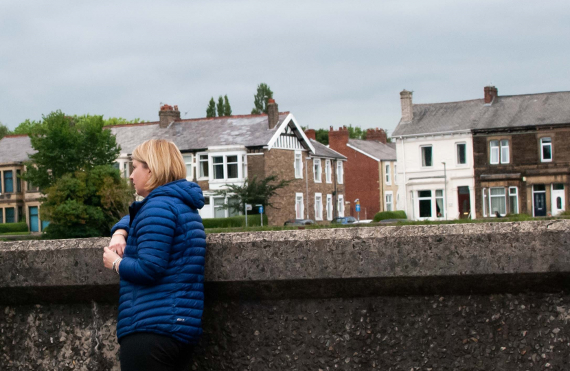 Katherine chatting in front of some houses