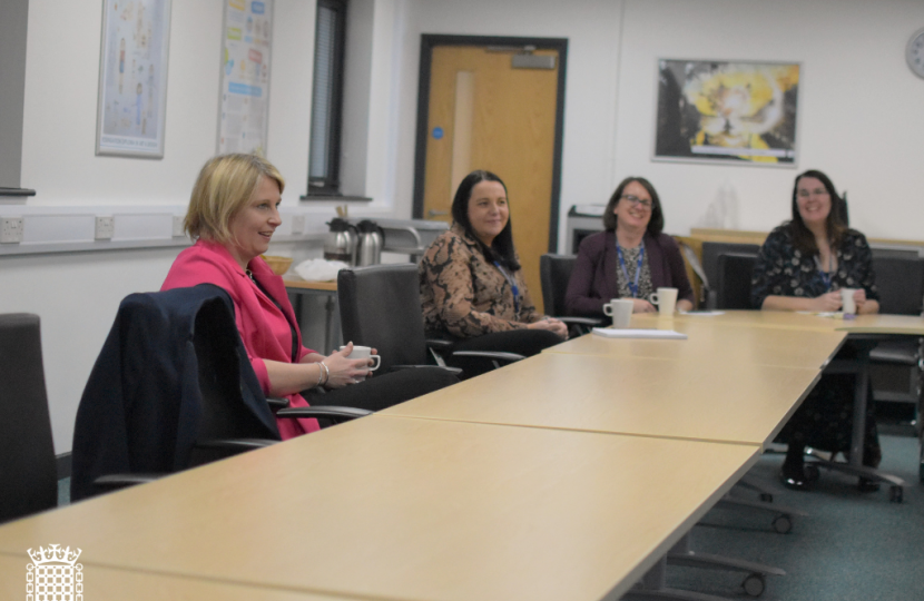 Katherine Fletcher sat at a desk at Runshaw College, talking to staff members and students.