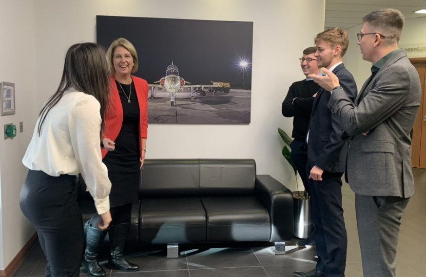 Katherine laughing with a group of apprentices