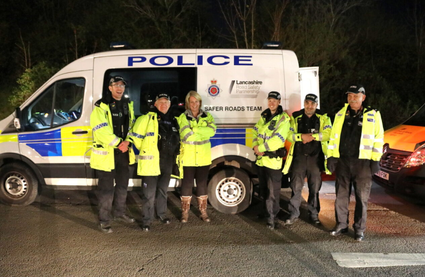 Katherine standing in front of police van with police team