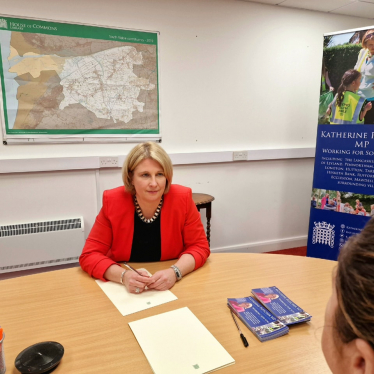 Katherine Fletcher sat at a table, opposite a constituent.