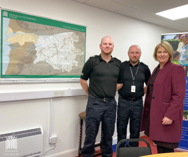 Katherine Fletcher stood in a room with two police officers. A map of South Ribble is behind them.