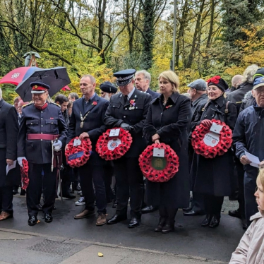 Katherine in a group photo holding a wreath