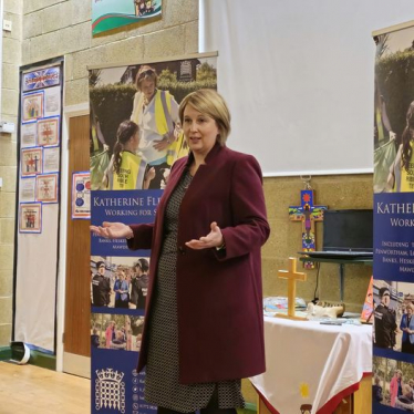 Katherine speaking at front of school hall