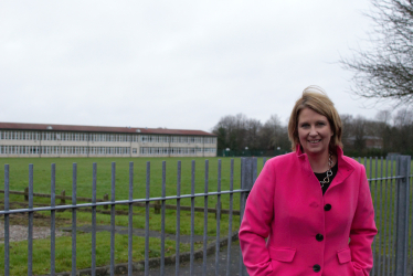 Katherine standing in front of the school