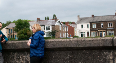 Katherine chatting in front of some houses