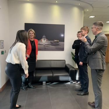 Katherine laughing with a group of apprentices