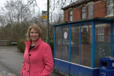 Katherine standing at a bus stop