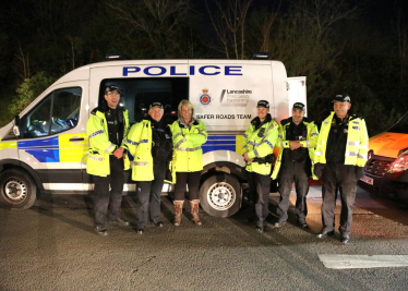 Katherine standing in front of police van with police team